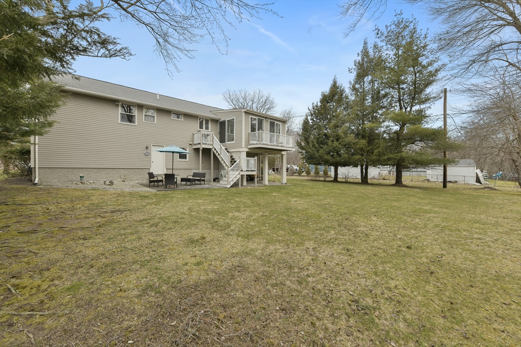 4 Coach Lane Dedham, MA 02026 - Photo 30 of 32 a view of a house with a yard