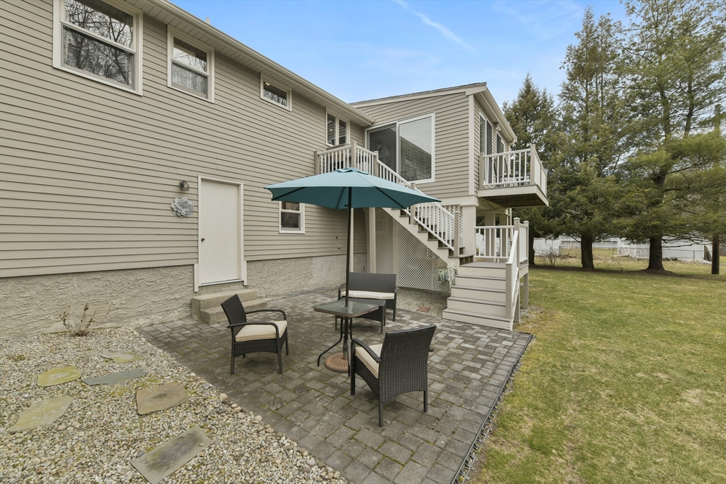 4 Coach Lane Dedham, MA 02026 - Photo 31 of 32 a view of a house with backyard and sitting area