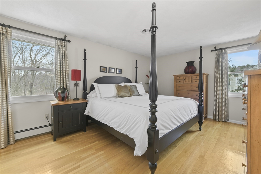 4 Coach Lane Dedham, MA 02026 - Photo 6 of 32 a bedroom with a bed and large window