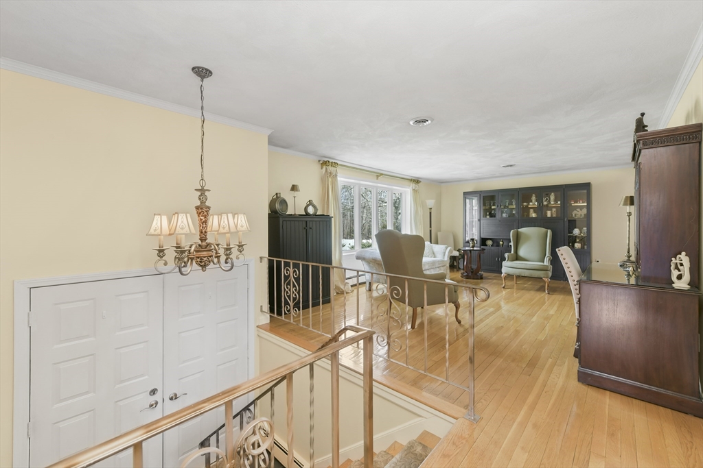 4 Coach Lane Dedham, MA 02026 - Photo 9 of 32 a view of a living room and chandelier