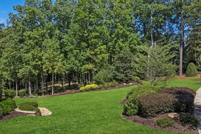an aerial view of a house with a yard and lake view