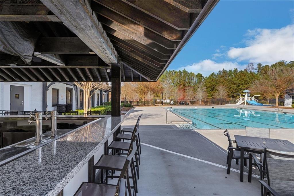 6218 Zell Miller Path Acworth, GA 30101 - Photo 43 of 53 a view of a patio with table and chairs with wooden floor and fence
