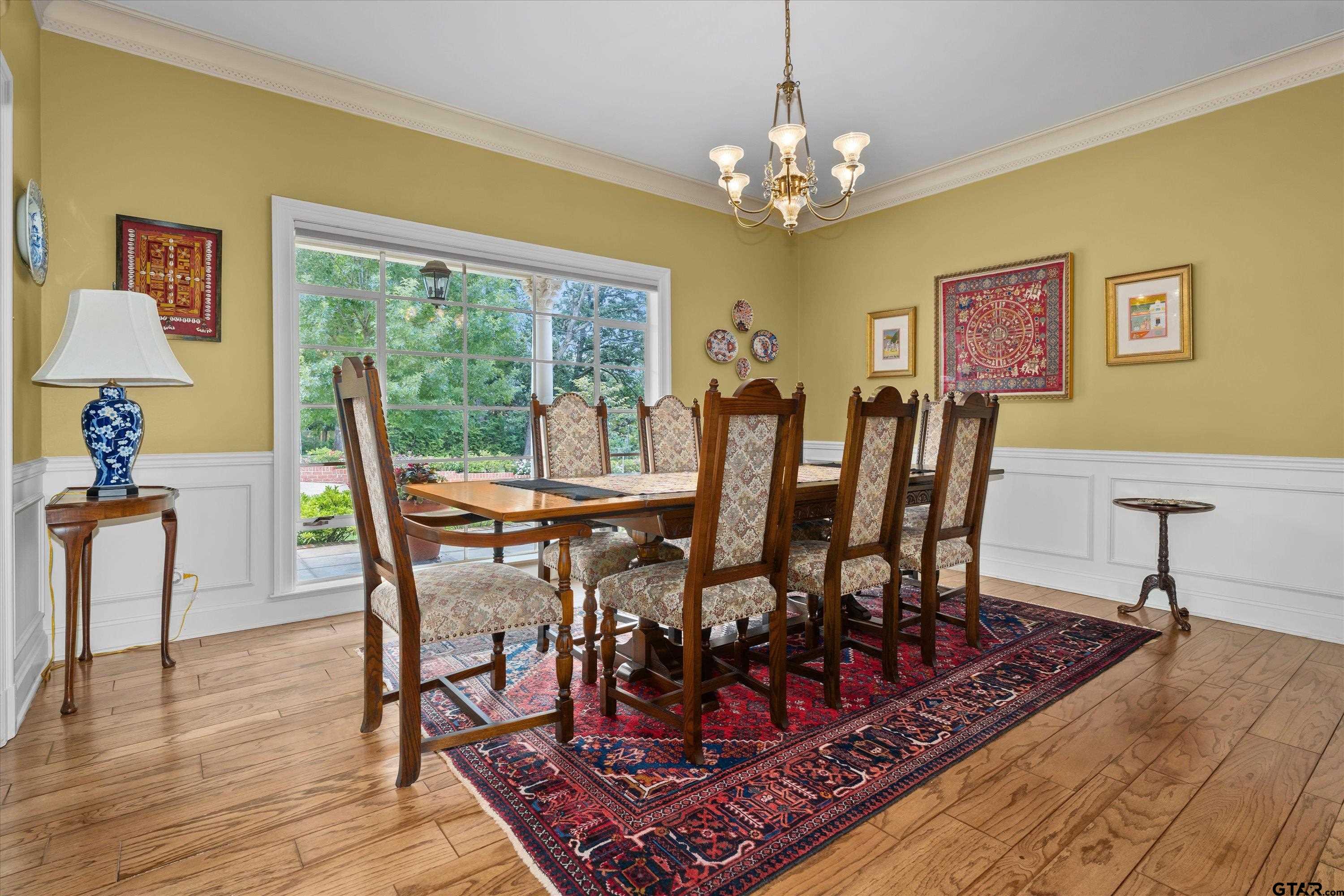 121 Fair Lane Tyler, TX 75701 - Photo 12 of 46 a view of a dining room with furniture a chandelier and wooden floor