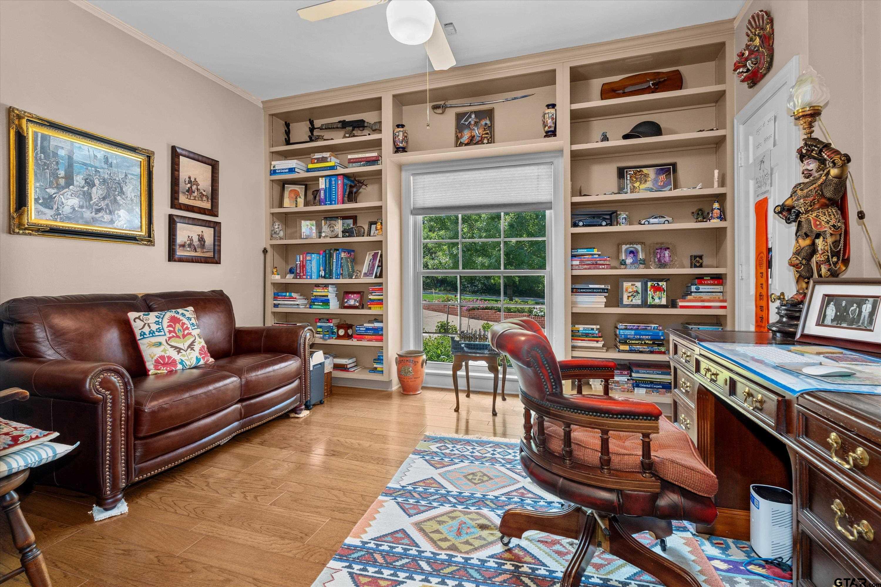 121 Fair Lane Tyler, TX 75701 - Photo 13 of 46 a living room with furniture a book shelf and a bookshelf