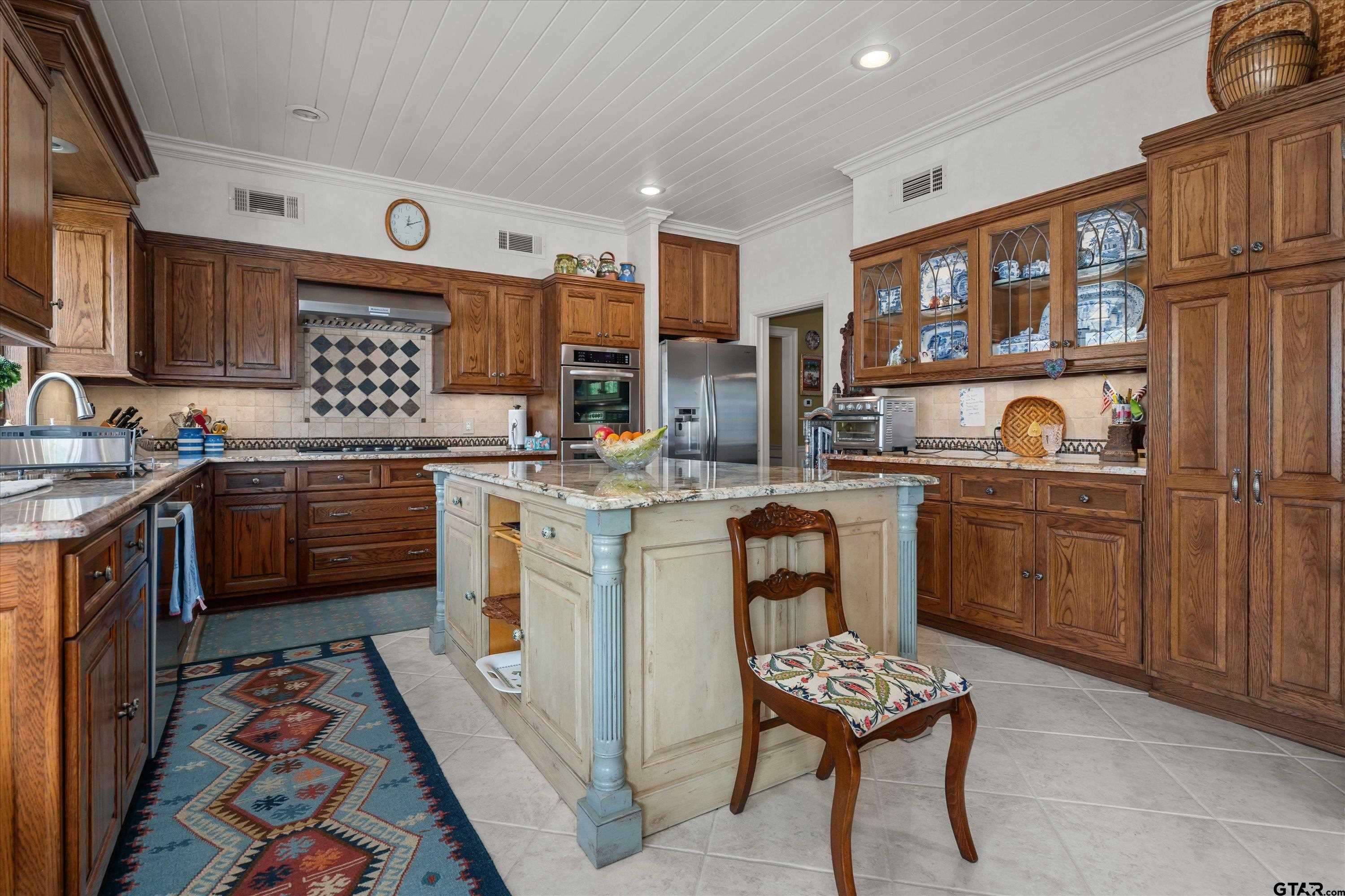 121 Fair Lane Tyler, TX 75701 - Photo 16 of 46 a kitchen with a sink stove and cabinets