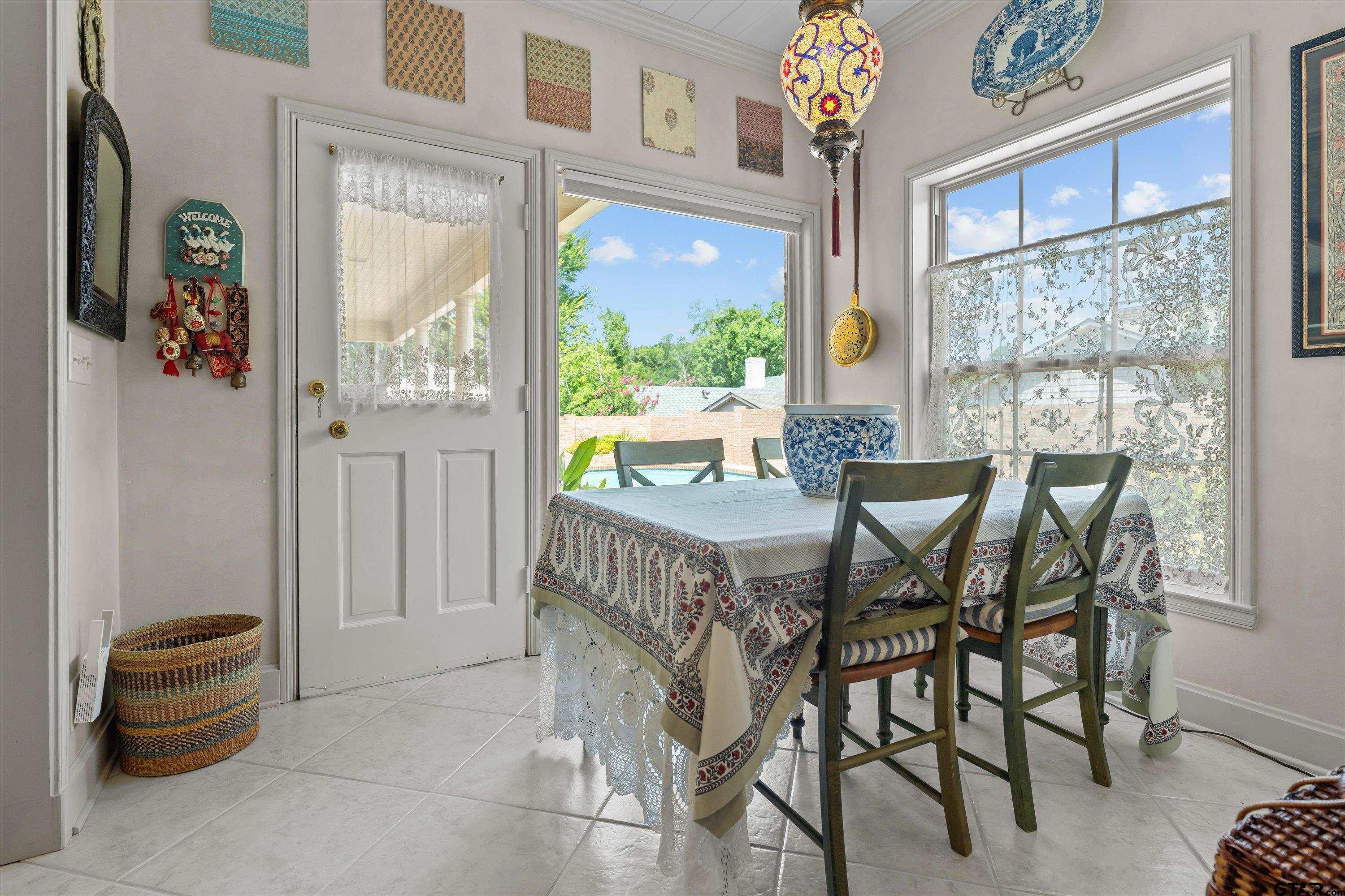 121 Fair Lane Tyler, TX 75701 - Photo 19 of 46 a dining room with furniture a chandelier and a rug