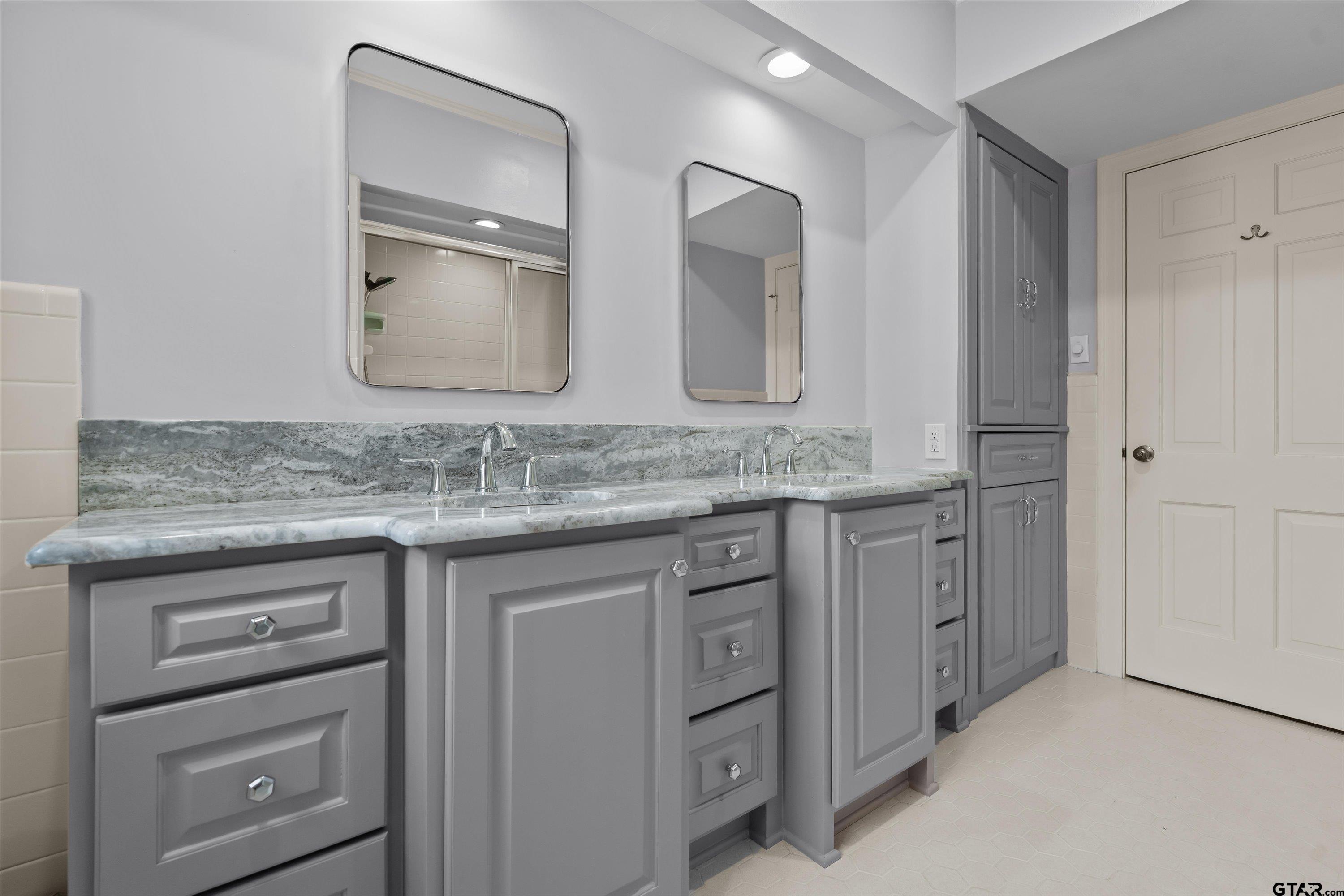 121 Fair Lane Tyler, TX 75701 - Photo 28 of 46 a bathroom with a granite countertop sink vanity and mirror