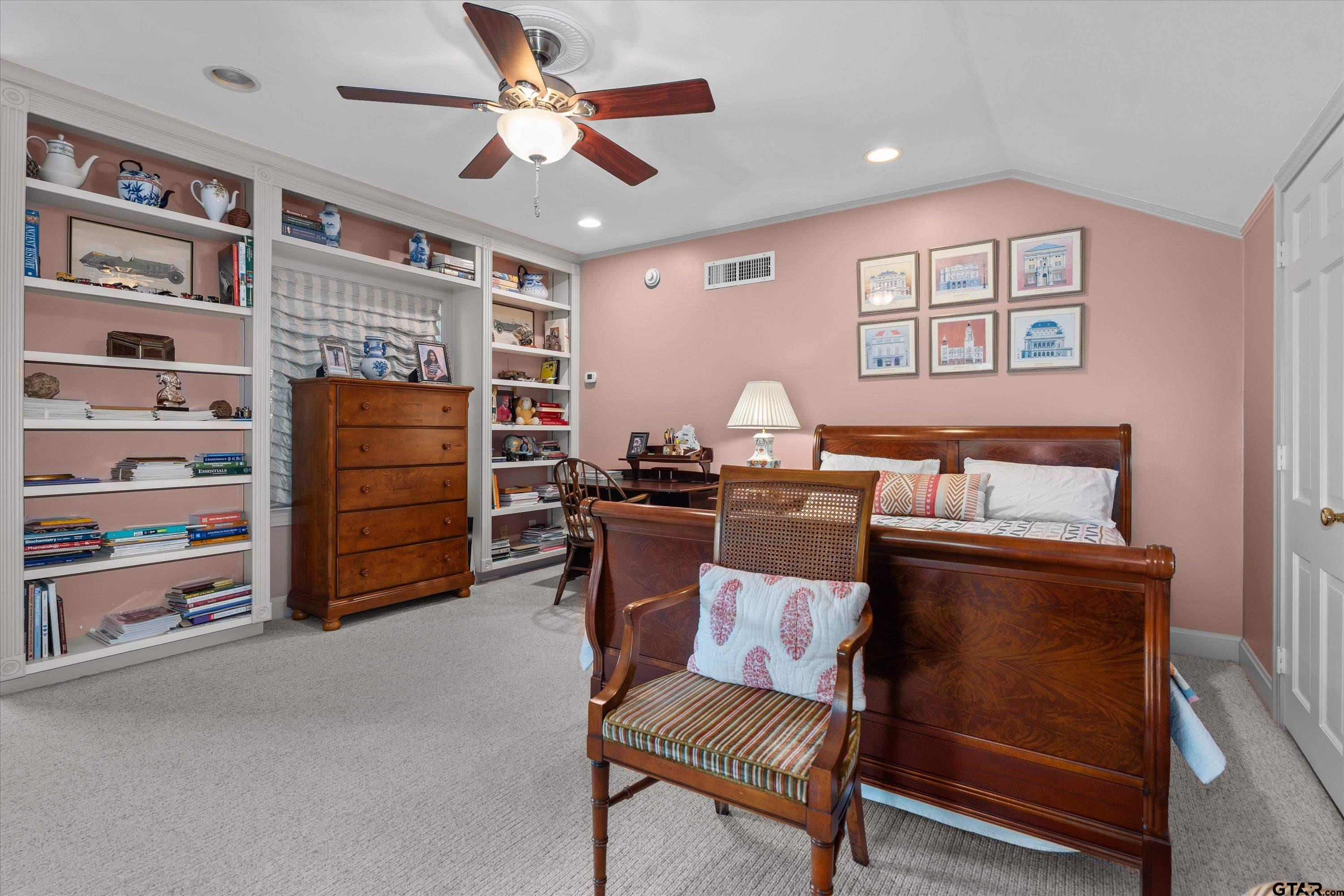 121 Fair Lane Tyler, TX 75701 - Photo 30 of 46 a living room with furniture and a bookshelf
