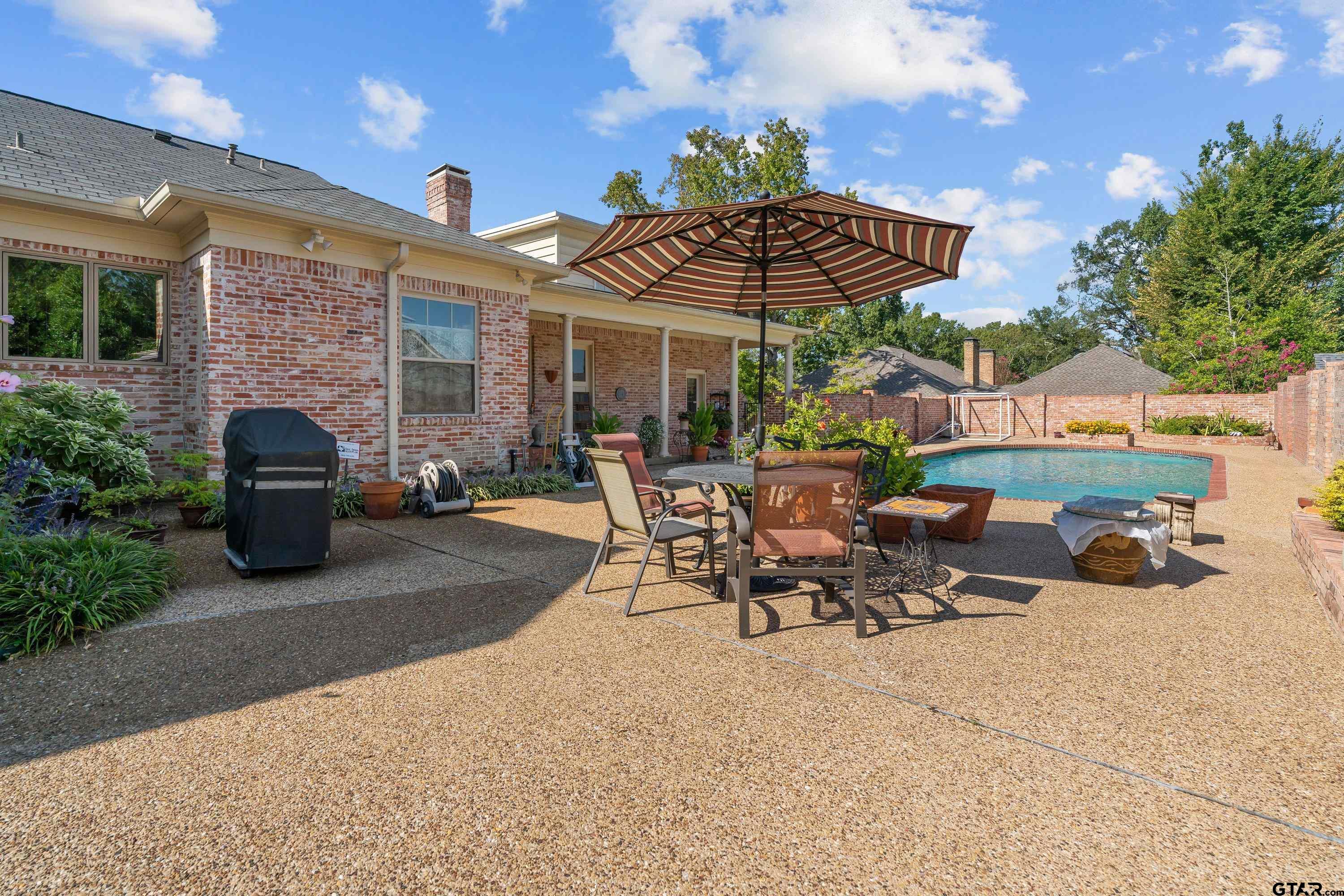 121 Fair Lane Tyler, TX 75701 - Photo 42 of 46 a view of a patio with a table and chairs under an umbrella