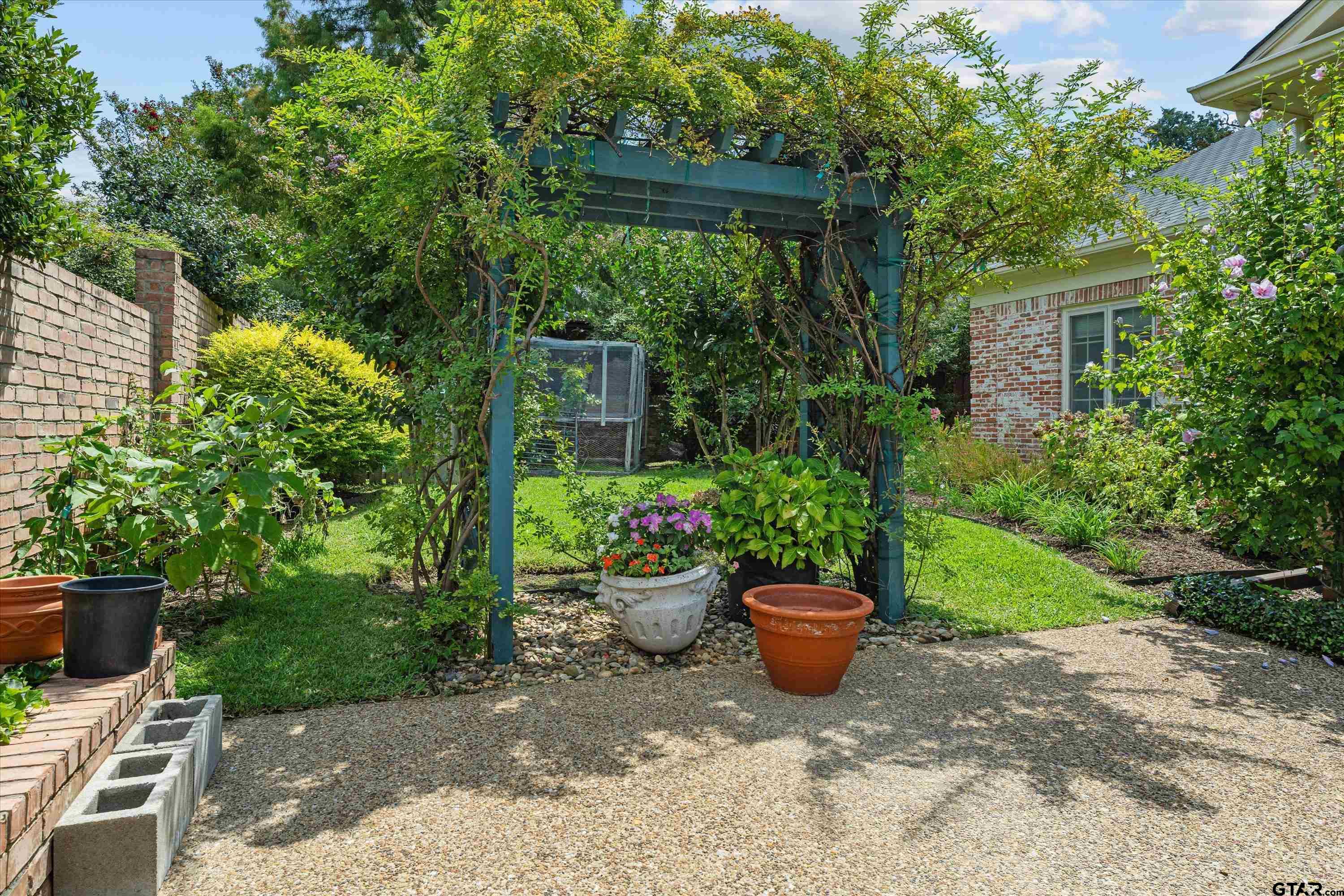 121 Fair Lane Tyler, TX 75701 - Photo 43 of 46 a view of a backyard with garden and plants
