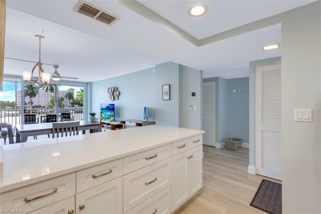 5 Bluebill Avenue, Unit 210 Naples, FL 34108 - Photo 9 of 26 a spacious bathroom with a sink a mirror and a bathtub