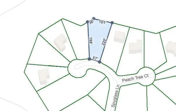 a view of a field of grass and trees