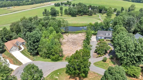 an aerial view of a house with outdoor space and a lake view