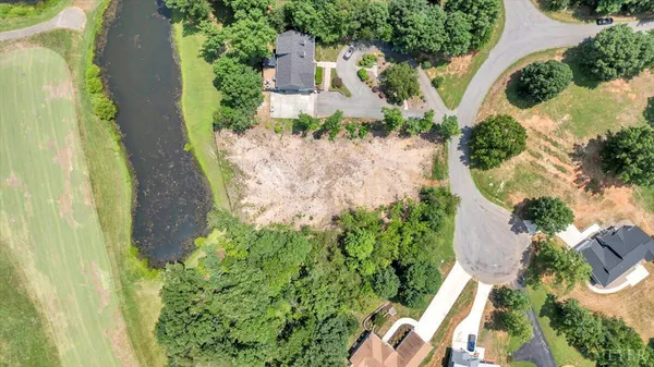 an aerial view of a house with a yard and garden