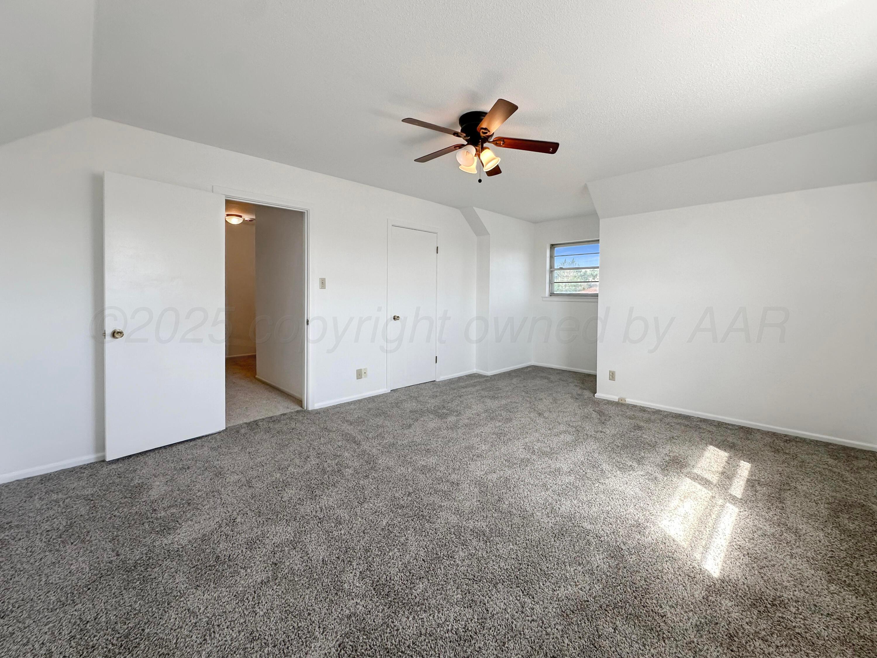 1421 Marigold Street Borger, TX 79007 - Photo 19 of 26 a view of a livingroom with a ceiling fan & window
