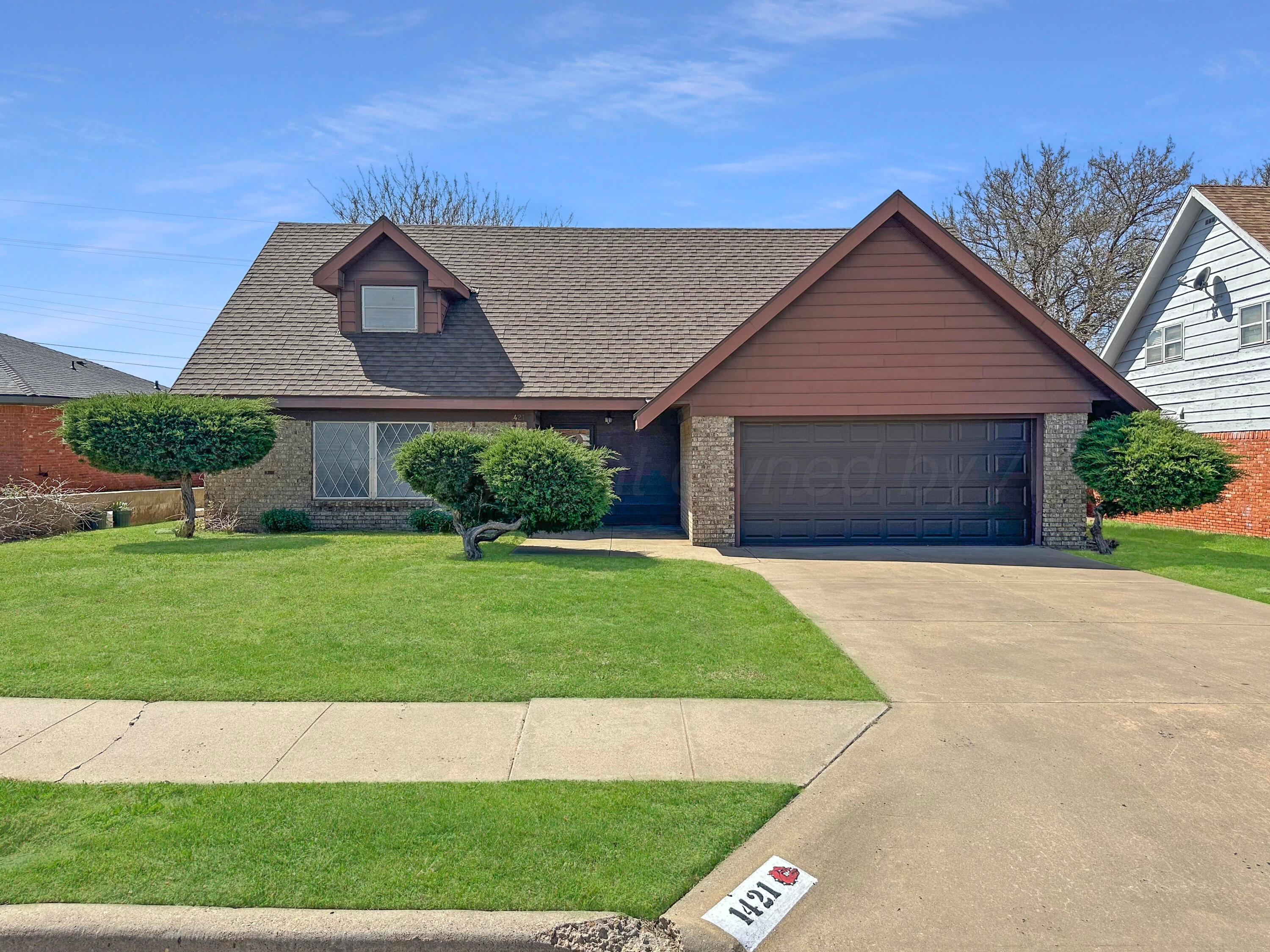 1421 Marigold Street Borger, TX 79007 - Photo 2 of 26 a front view of a house with a yard