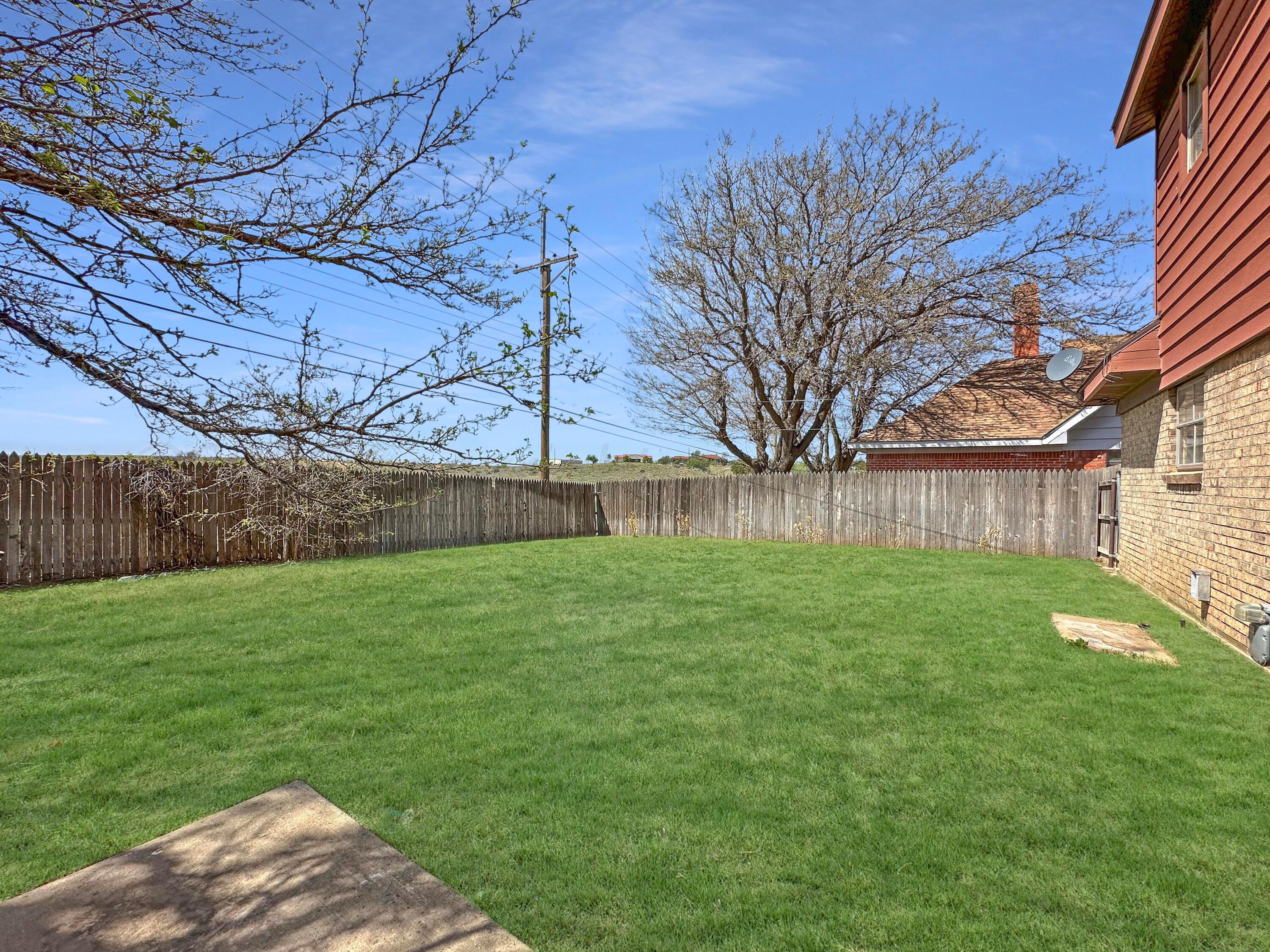 1421 Marigold Street Borger, TX 79007 - Photo 24 of 26 a view of a backyard with large trees