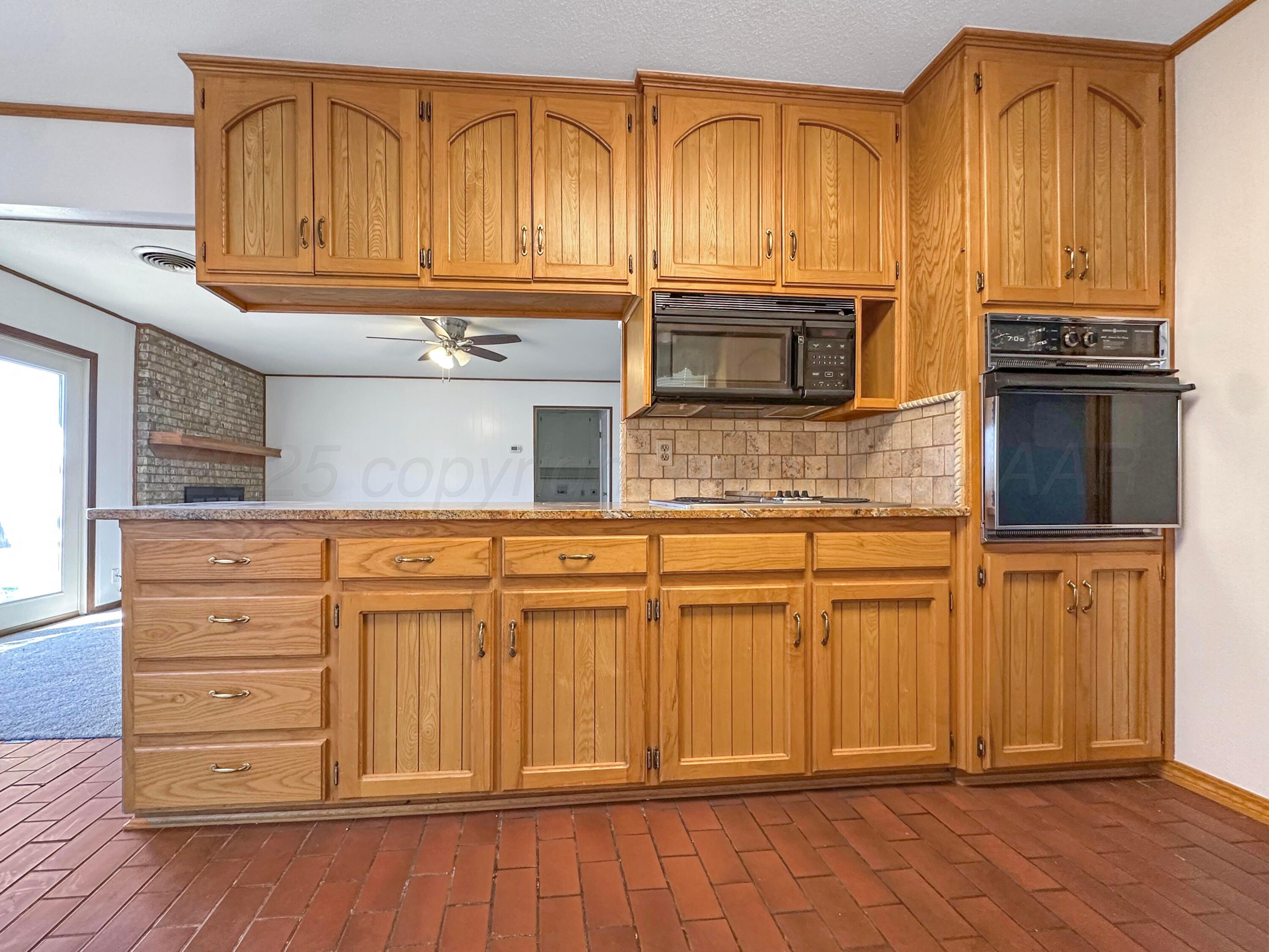 1421 Marigold Street Borger, TX 79007 - Photo 6 of 26 a kitchen with stainless steel appliances granite countertop a refrigerator oven stove a sink and dishwasher