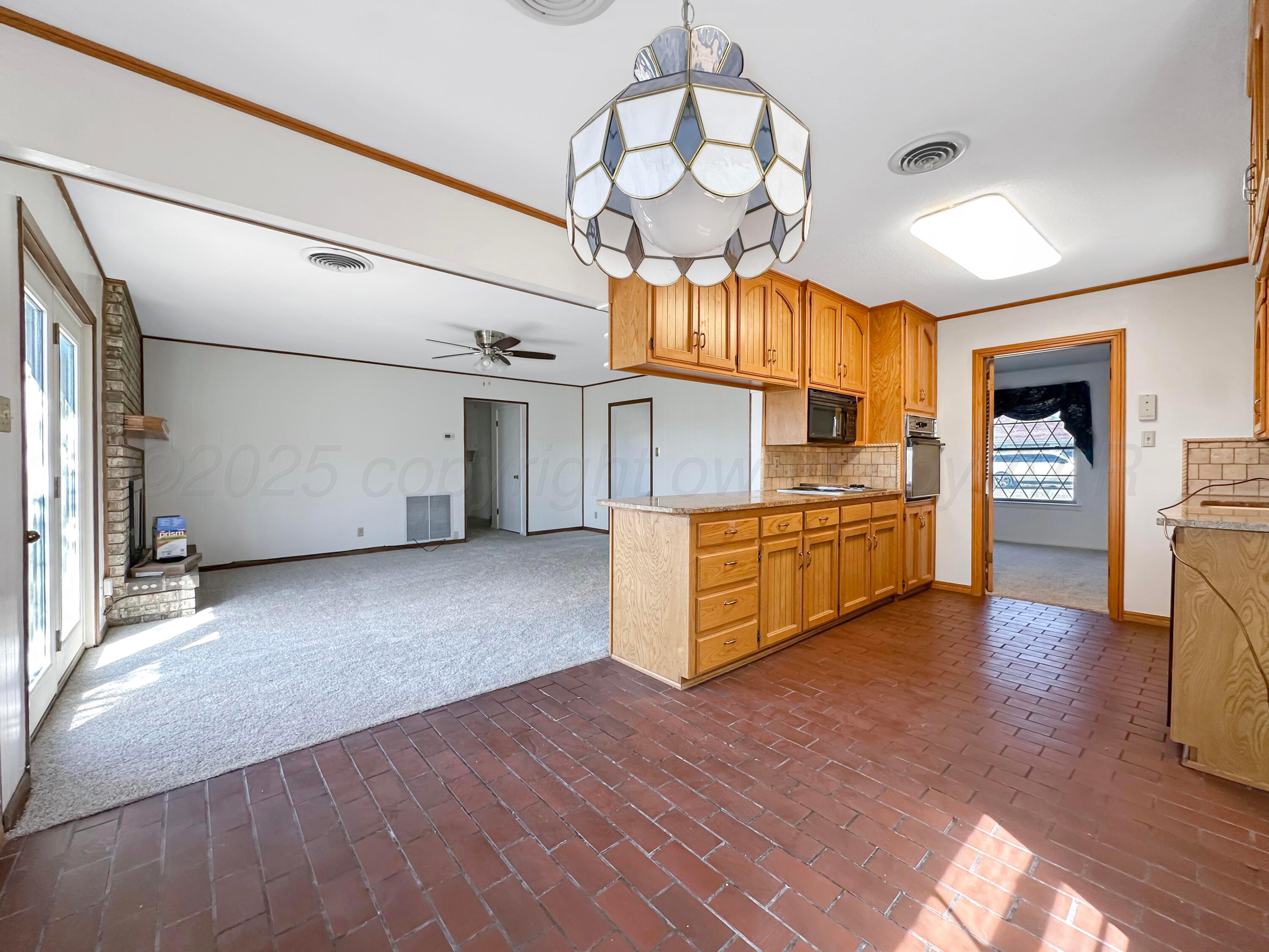 1421 Marigold Street Borger, TX 79007 - Photo 9 of 26 a view of a kitchen with a sink and cabinets