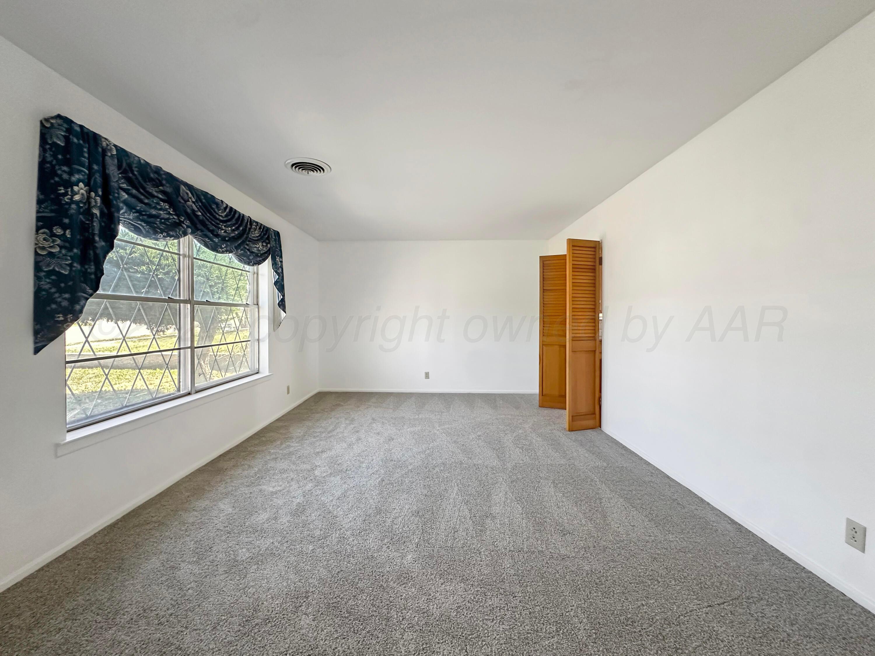 1421 Marigold Street Borger, TX 79007 - Photo 10 of 26 a view of an empty room with a window