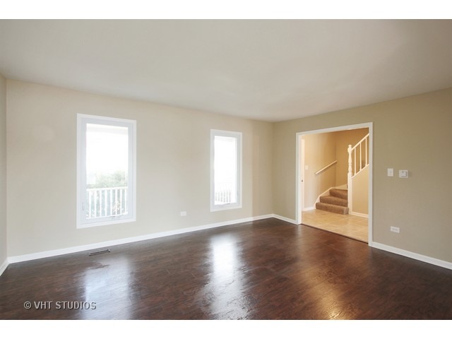 382 Northgate Road Lindenhurst, IL 60046 - Photo 2 of 10 a view of an empty room with wooden floor and a window