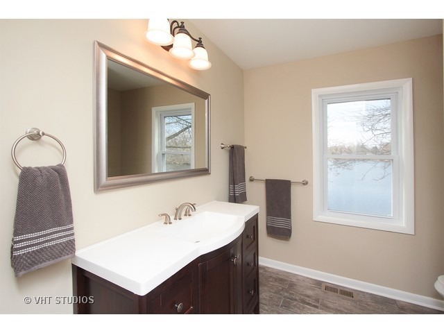 382 Northgate Road Lindenhurst, IL 60046 - Photo 9 of 10 a bathroom with a sink vanity and a mirror