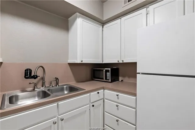 a kitchen with a sink and a refrigerator