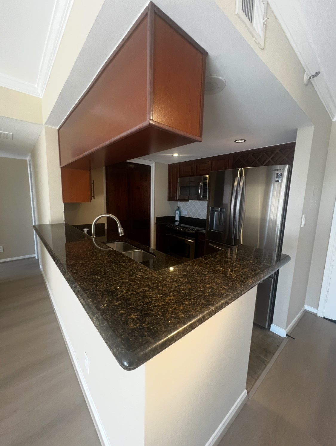 3525 Sage Road, Unit 1708 Houston, TX 77056 - Photo 5 of 14 a kitchen with stainless steel appliances granite countertop a sink and a refrigerator