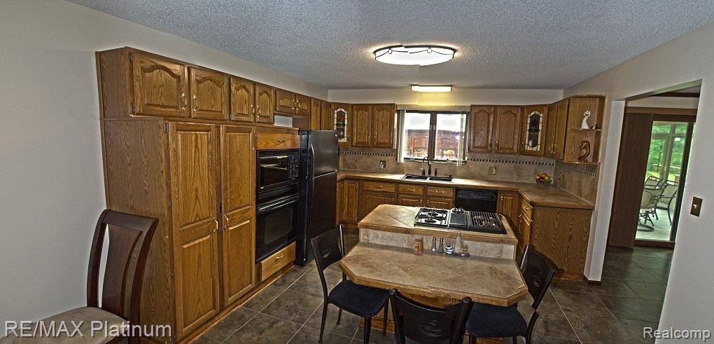 8547 Lake Road Grosse Ile, MI 48138 - Photo 6 of 17 AMPLE KITCHEN WITH BUILT-INS, ISLAND AND BREAKFAST BAR