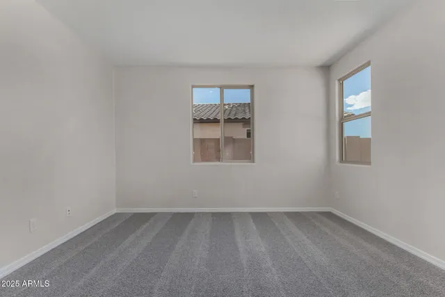 an empty room with a empty space and windows