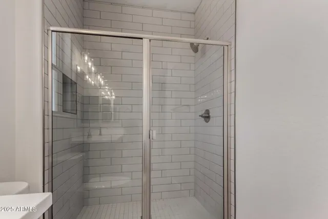 a bathroom with a glass door shower