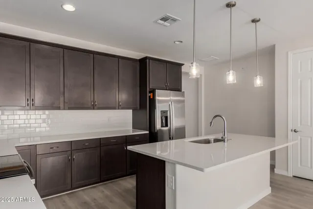 a kitchen with a sink cabinets and stainless steel appliances