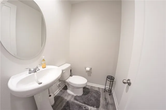 a bathroom with a sink toilet and a mirror
