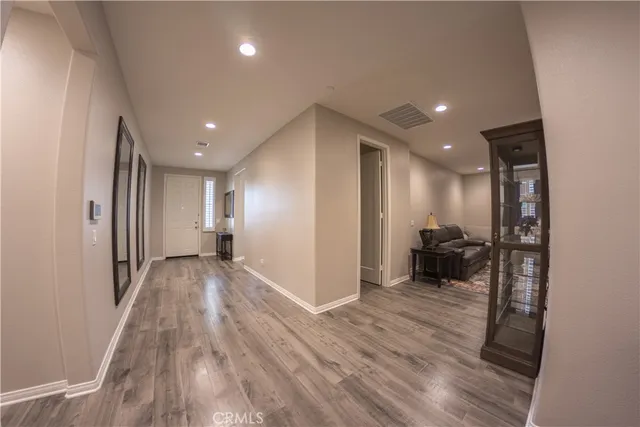 a view of a hallway with a couch and a wooden floor