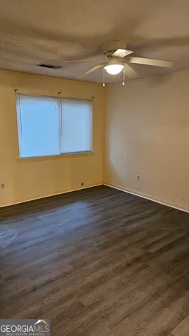 a view of room with wooden floor