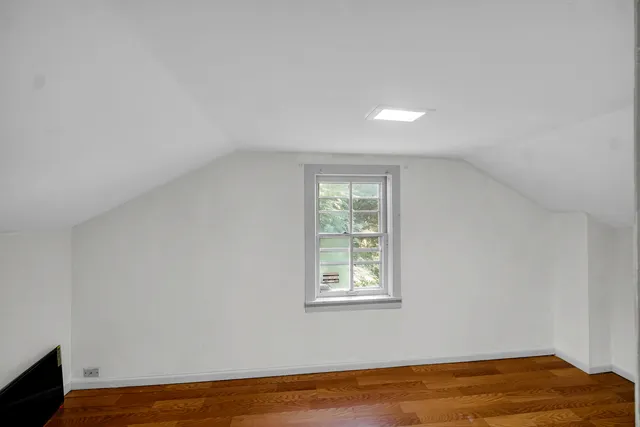 a view of a room with wooden floor and fan