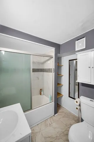 a bathroom with a bathtub and a toilet