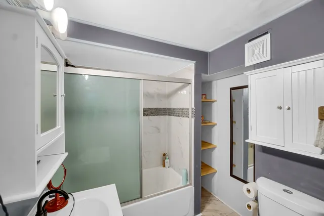 a bathroom with a bathtub and a shower