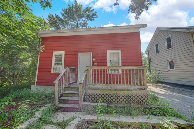 a front view of a house with a bench