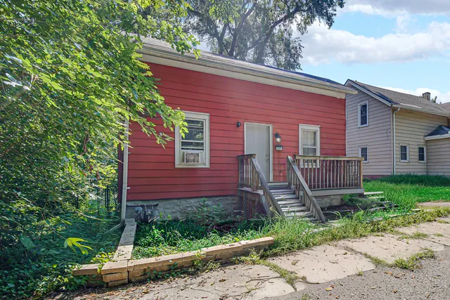 a front view of a house with a garden