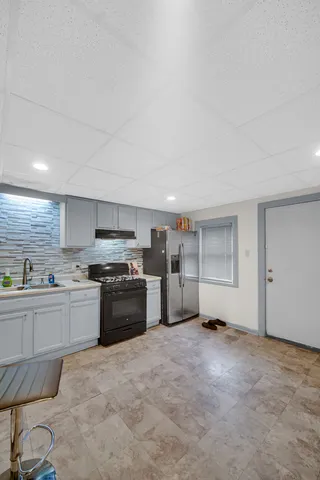 a kitchen with stainless steel appliances granite countertop a stove and a refrigerator