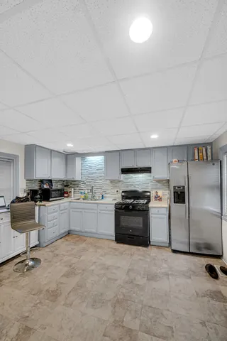 a kitchen with a sink stainless steel appliances and cabinets