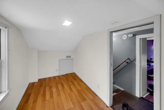 a view of a room with wooden floor and staircase