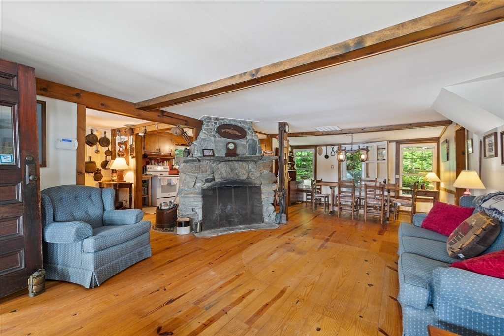 35 Mt Dan Road Sturbridge, MA 01518 - Photo 12 of 37 a living room with furniture fireplace and a large window
