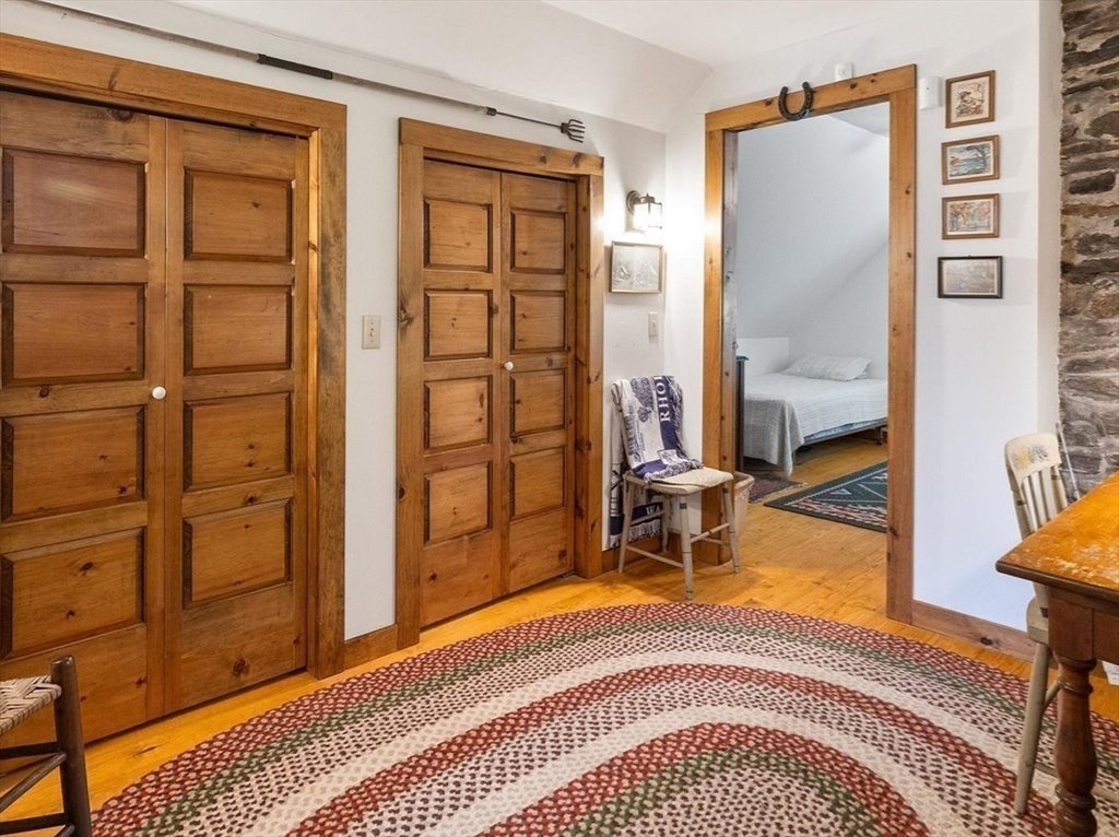 35 Mt Dan Road Sturbridge, MA 01518 - Photo 17 of 37 a bedroom with a bed and wooden floor