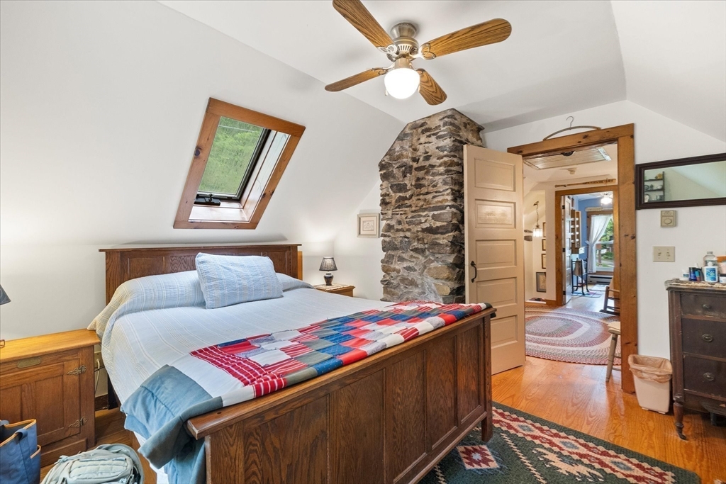 35 Mt Dan Road Sturbridge, MA 01518 - Photo 19 of 37 a bedroom with a bed and a chandelier