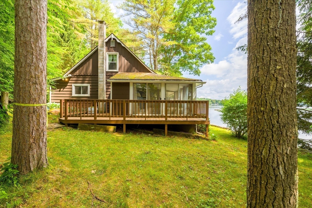 35 Mt Dan Road Sturbridge, MA 01518 - Photo 30 of 37 a view of a house with a wooden deck and a big yard