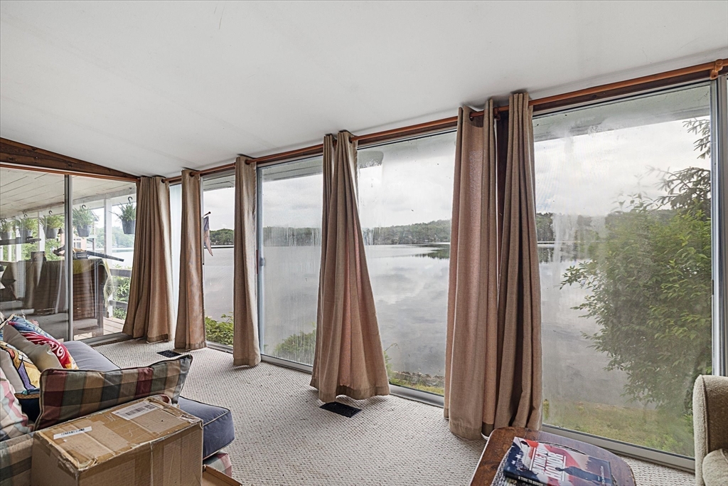 35 Mt Dan Road Sturbridge, MA 01518 - Photo 8 of 37 a living room with a large window and a glass door