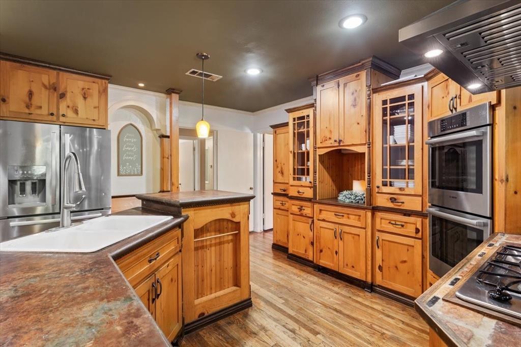 3015 Sturgis Lane Waco, TX 76708 - Photo 13 of 40 a kitchen with stainless steel appliances granite countertop a stove and a sink