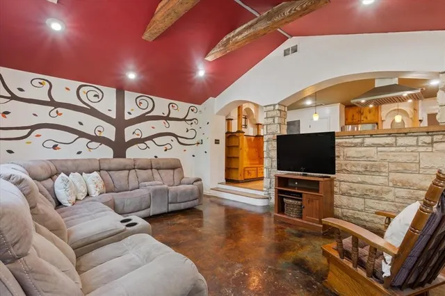 a living room with furniture and a flat screen tv
